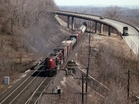 I'm assuming this is a Hamilton to Brantford local, even though it is powered by Geeps I used to see hanging out at Fort Erie. The 4560 and 4521 are seen westbound about mile 4, Dundas Sub. That is the Sydenham Rd bridge in the background. The image was captured from high above in that old Canada Crushed Stone structure that ferried crushed rock over the track to the stockpiles on the south side. Long gone.