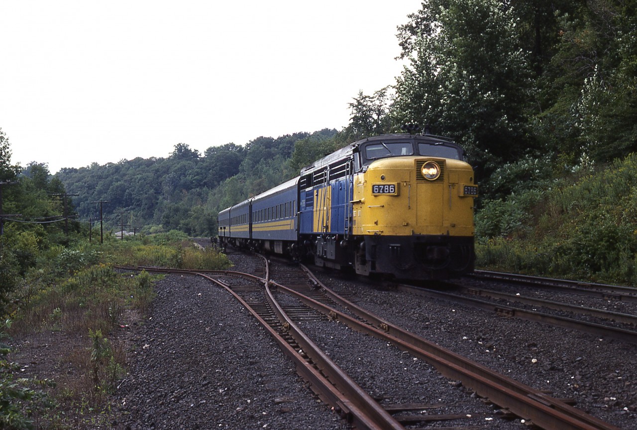 Train 76 with an abbreviated consist, gliding past the old crossovers and 'switchback' leading to Steetley Canada, an eighth of a mile east of the former station. The classy FPA4 looks barren on the nose, not having a logo or a set of ditchlights. Another example of being in MooneyLand but not crossing paths.