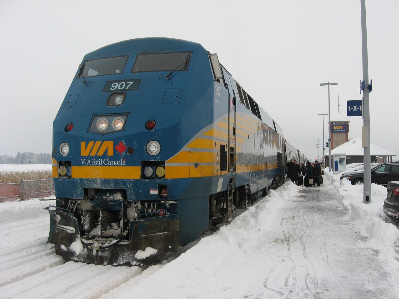 VIA AT FALLOWFIELD. While fulfilling a promise to my Father-in-Law Johnny (see ID 27380), it gave this Newfoundland & Labrador railfan a chance to capture some VIA Rail action. Due to the December 2013 North American storm complex, rail and highway traffic was disrupted and as a result, VIA Rail Train 51 was well past its 08:45 departure time from Fallowfield. Due to the delay caused by the ice storm, I was able to witness, along with Johnny and my youngest son Thomas who would later accompany us to Montreal on VIA Rail # 32, a full passenger train led by P42DC 907 en route to Toronto. Rail scenes like these, not witnessed on the Rock since 1988, certainly added to that special Christmas in our Nations's Capital.