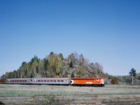 In what looks like a model railroad, 4068 exits the wye at Labelle near Mont Tremblant. This was a fall colours excursion from Montreal. All passengers got a turn in one of the dome cars. photo by my mother, scan by my brother.