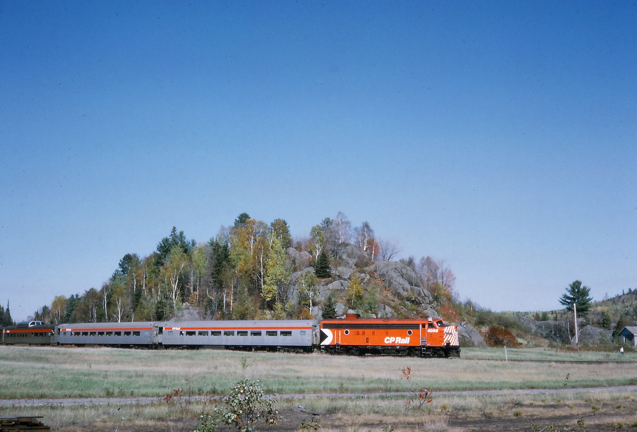 In what looks like a model railroad, 4068 exits the wye at Labelle near Mont Tremblant. This was a fall colours excursion from Montreal. All passengers got a turn in one of the dome cars. photo by my mother, scan by my brother.
