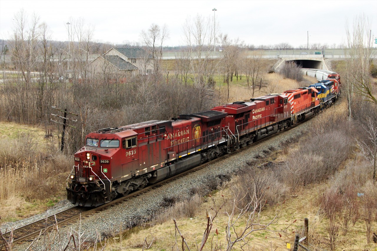 As is typically the case, the best trains come by in the worst weather. After catching this guy from the truck window at Victoria Road crossing on the Galt sub in the pouring rain, and seeing the four SD40-2 and Sd40-3's, the race was on to get a side shot instead of the nose shot I had. So here is CP 254 led by CP 9639 and CP 8772 with SD40-3, KLWX 6092 and  KLWX 6211, and SD40-2 KLWX 5727 and KLWX 5749 headed under the Highway six bridge on its way to Desjardins.