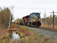 Container train, CP 142, led by CEFX 1028 and CP 9610 races over Concession 7 in Puslinch on a typical spring rainy morning. It sure is nice to see the spring colors returning and help us get rid of the winter browns.