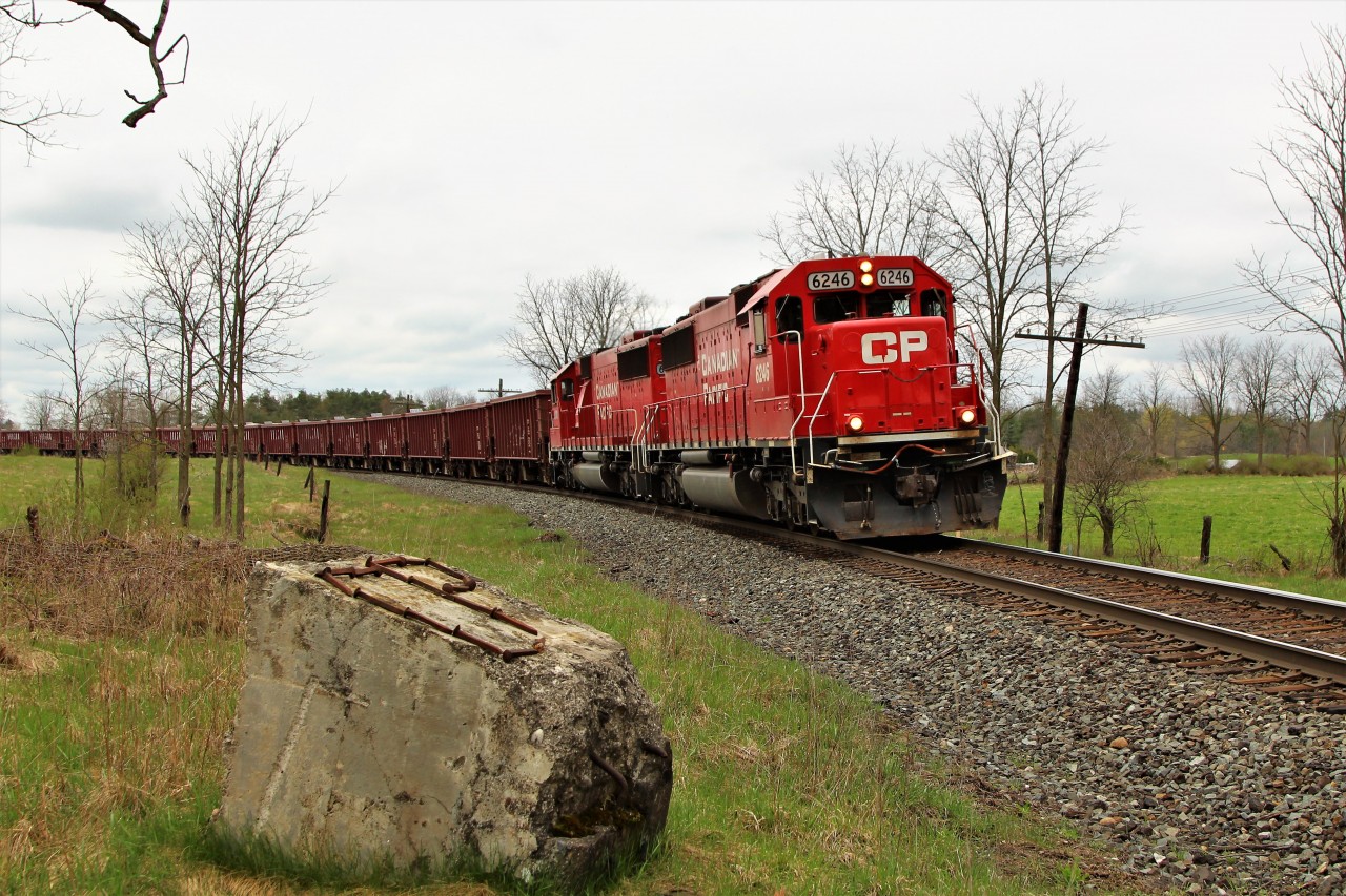 A nice clean pair of SD60's in CP 6246 and CP 6240 bank their way around the bend after just having crossed Victoria Road in Puslinch with a 2200 foot load of ballast cars.