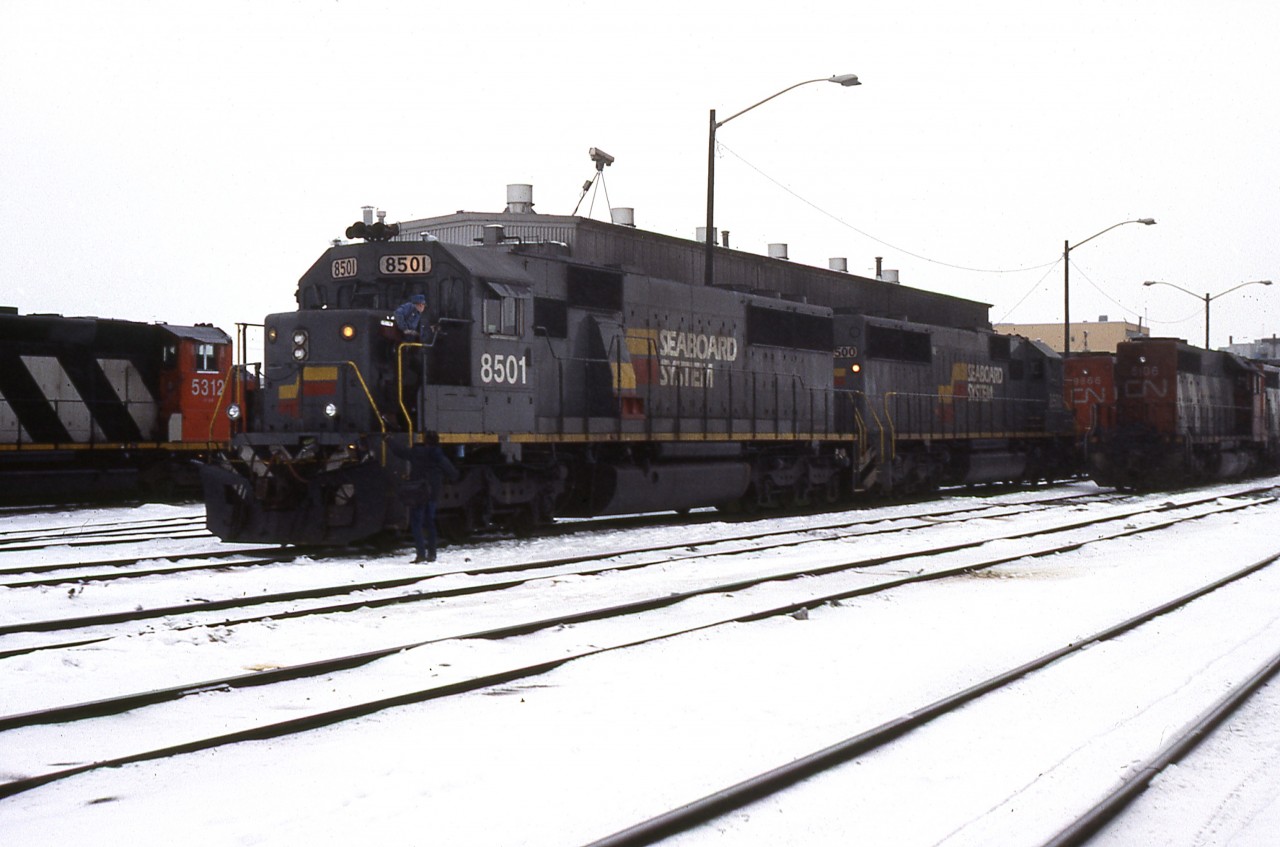 A Doug Lawson photo.
In early January 1984, CN borrowed a pair of 1-year old Seaboard SD50's to test the latest offerings from EMD. It was a mutual deal, as CN provided SBD with a near-equivalent in horsepower by loaning the U.S. road 3 SD40's - 5124, 5127 and 5130. The test period was 30 days and basically took place between Vancouver and Edmonton. Here an outgoing crew is about to take charge of the LaGrange products coming off the shop track, while other London-built units await their turn.