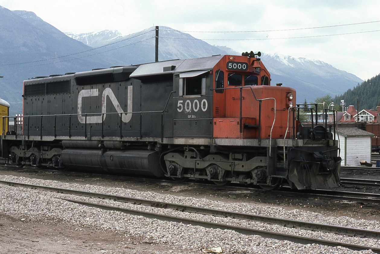 A Carl Bury image. In September 1975 the Brantford resident did a driving trip to the western provinces. One of his classic discoveries was CN's first SD40 resting between road trips at Jasper AB, already showing signs of heavy use after 8 years of age.
Make no mistake, this is THE unit of the class. Unfortunately, having lasted until Dec2006 on the active roster, she met the torch at Lac La Biche AB during June2007 after efforts for preservation fell short.