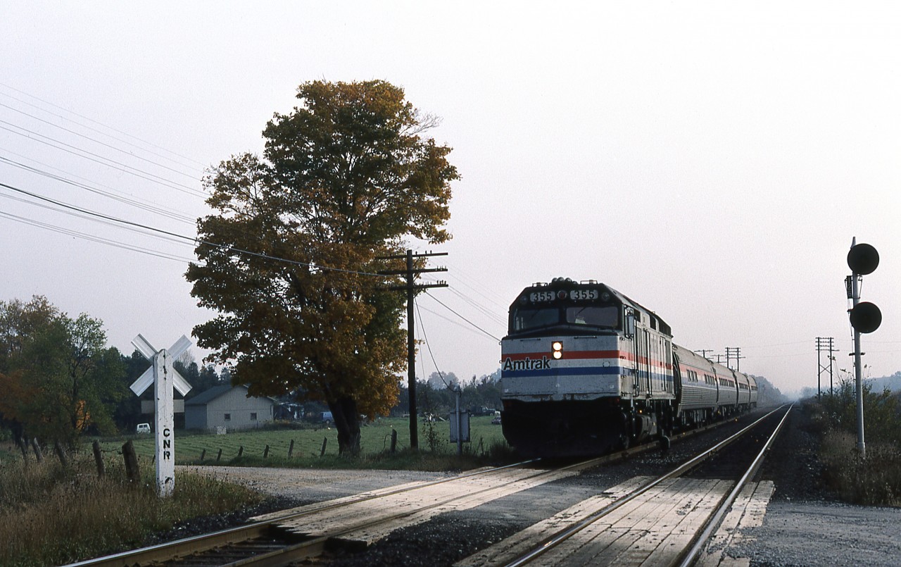 THE INTERNATIONAL, combined Toronto-Chicago service operated jointly by VIA Rail Canada and Amtrak. Train 81 has 4 Amfleet cars behind F40PH 355 as it crosses Amiens Road immediately west of the diamond with CP's Windsor Sub.
This location would later have a connecting track installed between CN and CP and be given the name MELROSE. CTC installation on the Strathroy Sub. is also a number of years away.
