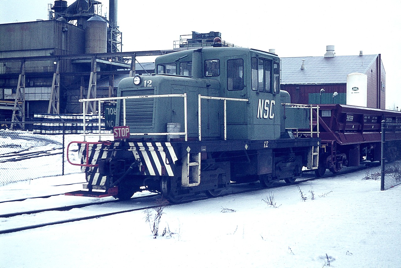 National Steel Car #12, in it's old paint scheme, working on company property in the industrial north end. This 50Tonner was acquired new and fitted with remote control.