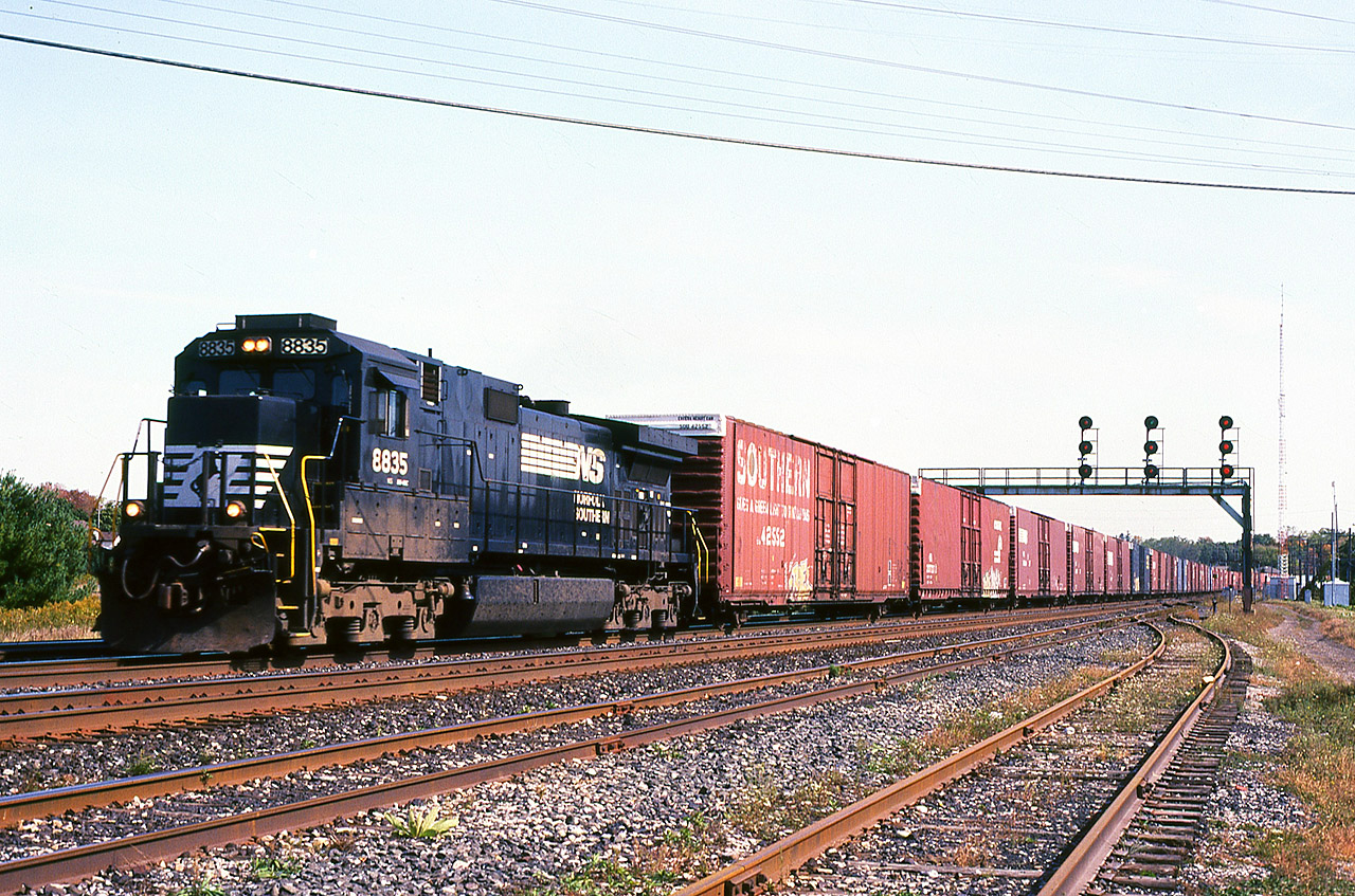 Norfolk Southern Buffalo-St. Thomas train 327 with a single Dash 9-40C is doing his best to maintain track speed with a large contingent of hi-cubes at CN Paris Jct. Train 327 had settled into a fairly reliable timeframe during 2004, 2005, making it easy to catch whatever motive power NS could scrounge up for it's valuable Ford Talbotville run. And unless something out of the ordinary happened, the same power would be bringing 328 back the following morning. So just like the CERTS breath mint commercial, it would be "two..two.. two [chances] in one' to catch the power.