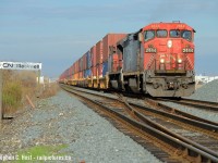 As clouds rapidly move in, CN 148 gets under way after a lift in Sarnia's "A" yard, with a classically Canadian Cowl unit in the lead.