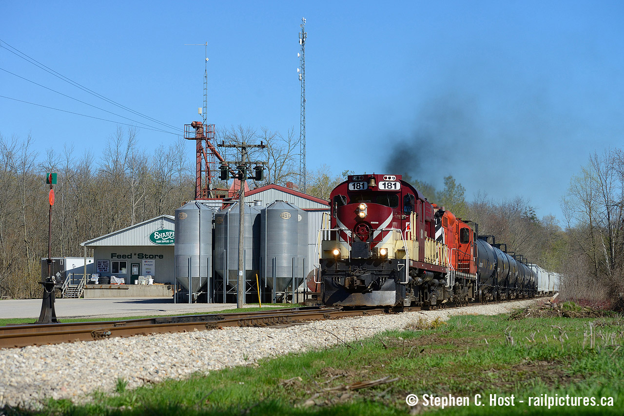 Well, this is a rare scene - how often does OSR depart Guelph Junction in the mid to late afternoon? It's 4:14 PM and the crew has departed the junction after putting together their train. If only OSR ran this late on a regular basis - it makes for some great photo opportunities. 181 and 1591 are giving 'er as the crew guides their train to track speed on GJR's class 3 track, passing the Sharpe Feed Mill in Moffat.