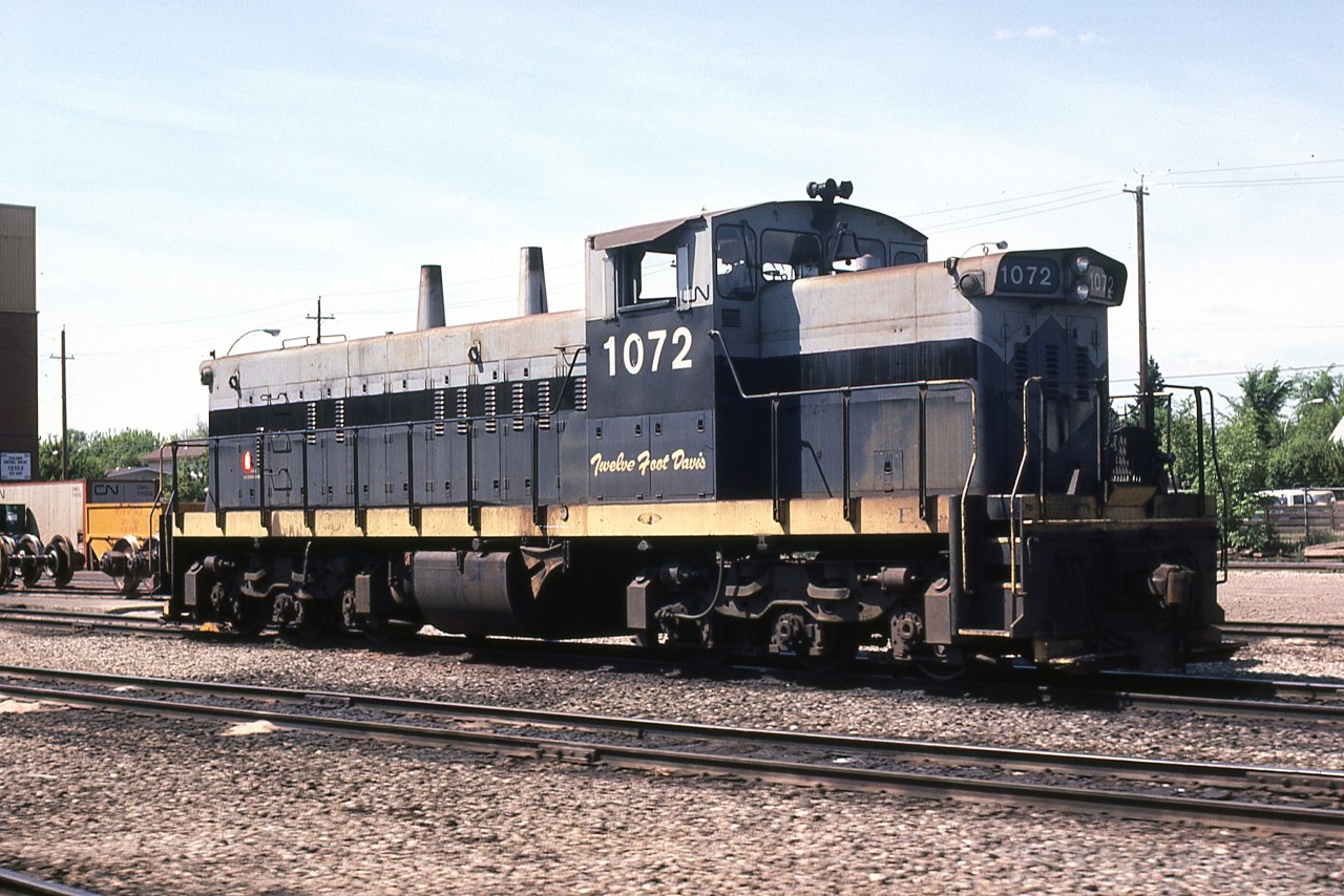 A Doug Lawson photo.
Former NAR GMD-1 311 has been renumbered back to it's original CN number after the Canadian regional property became 100% CN-owned in January 1981. These engines were all built new for CN with the A-1-A trucks for branchline service. 1072 spent time as NAR 311 from Jan1962 until Jan1981. It later became CN 1182. As was the classy touch of NAR, it carried the name TWELVE FOOT DAVIS. NAR named all of it's engines starting in about 1970 for local people and places. 1172 was retired by CN in Sept1999, was resold to a broker who then sold it to Southern Rly of BC, renumbered SRY 1205; in late 2014 it was sold by SRY to broker J&L Consulting and was deemed to be in poor condition, hence was scrapped.