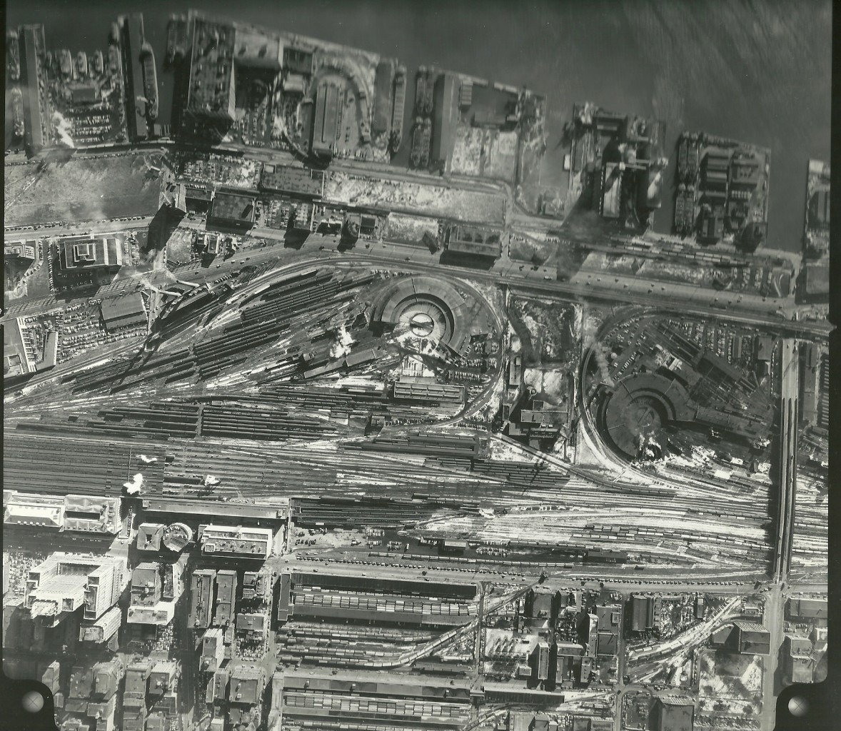 Aerial photo of Toronto rail yards for CN and CP. I believe this is from the 1930's as the freight yards on front and King are still present. Steam exhaust can been seen in several locations. This is 1 of 4 picture going from West to East. I have an enlargement of this one.
