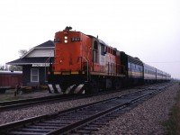 A Mike McIlwaine slide. VIA train 71 flies past the closed Stoney Point station on the final leg of it's journey from Toronto to Windsor. In deference to policy, the consist of 5 cars is being handled by 2 locomotives, but I'm sure there is an explanation. The 6 Tempo RS18's were not purchased by VIA, only leased for use in the Corridor. Wholesale changes were imminent as the F40's would be delivered starting in November 1986 and the Tempo cars would be sold off, replaced by dozens of second-hand ' heritage ' cars.