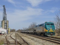 Train 73 passes the quiet sidings at Thamesville on a very sunny, yet quite warm Sunday afternoon. It is approaching the Victoria Road (Hwy 21) crossing with it's horn blaring. In the distance, you can see the gates coming up to allow traffic through once again at the Longwood Road (Hwy 2) crossing.