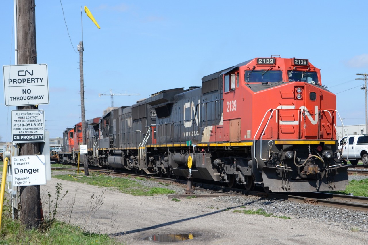 CN 509 starts pulling down into track 7 at London yard, and warning signs fill up the Light post on the westside of Egerton St.