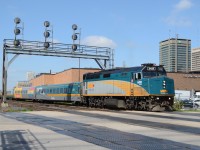 VIA train #72 pulls out of the VIA Rail London train station, and under the first Signals for the CN Dundas Sub, with London Free Press building in the background and other downtown London Buildings.