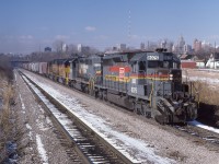 A mixed quartet of CSX power (8075-8165-4166-7516) brings the Rock Train up and out of the Detroit River Tunnel into Windsor, Ontario on March 15th 1983.  The Phospahte rock, originating in Florida will be interchanged to CP Rail for furtherance to Port Maitland.