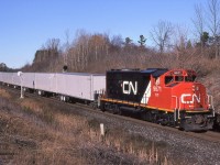  A nice clean CN 9671 leads train 145 as it splits the signals at Mile 30 (Scotch Block) Halton Sub, North of Milton Ontario on Oct 29th 2000 with ECOZ trailers.  