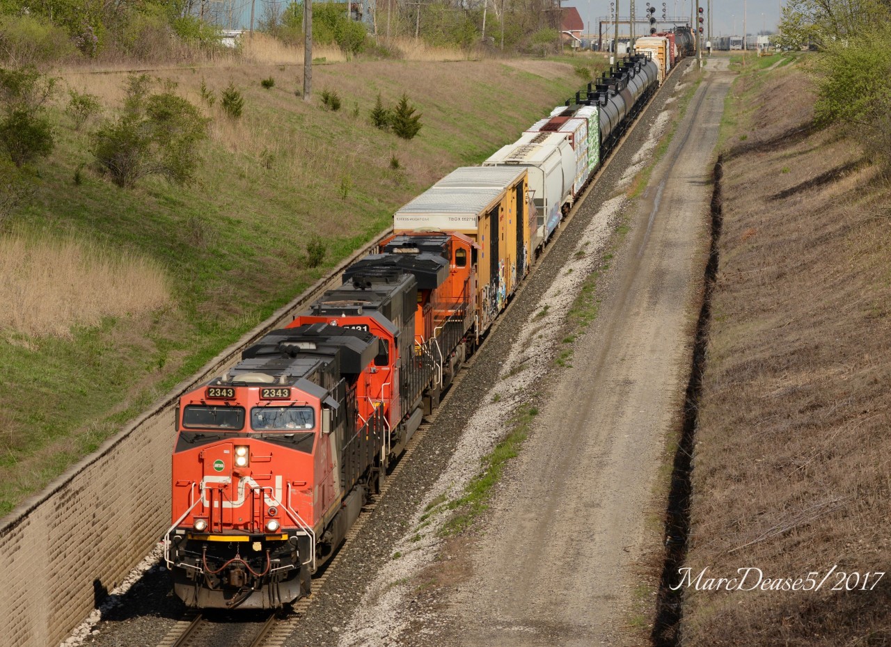 Train 371 heading to Port Huron, MI., with CN 2343, CN 5431 and a surprise trailing unit BNSF 7428.