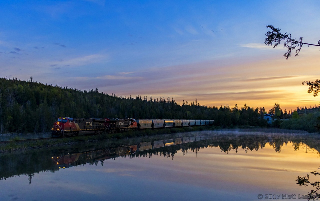 CN 2848 is westbound, as they lead a Canpotex potash train past the "unnamed lake", as they start their descent down into their final destination of Saint John, New Brunswick, with the sun on the rise!