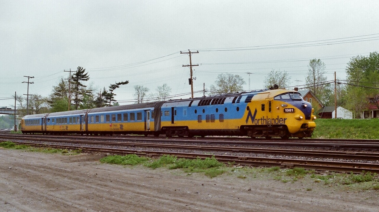 Werkspoor ' TEE ' #1981 powers Saturday only Northlander equipped VIA train #120 on approach to CN Washago.
 

Daily except Saturday Trains 121 and 122 were ONR operated  Northlander service, while weekend trains 120 on Saturday, 123 Friday and Sunday and 124 Sunday were Toronto / North Bay  service only and operated for VIA. 
 

The four Werkspoor 'TEE' *  units powered the four Northlander train sets at the 1976 introduction to Canada until mid 1980 when all trainsets were repowered with modified ONR FP7a units ( ONR 1519 to 1984 ; 1518 to 1985; 1501 to 1986; 1510 to 1987 ). Apparently the Werkspoor power was challenged by the northern Ontario operating conditions.
 

CN Washago  was impressive at one time with a  four track main passing under the highway #11 overpass: nearest track is the service track, next two is the Bala Subdivision siding and main, far side is Newmarket Subdivision siding and main, certainly looks different here today.
 

Also impressive, even up to 1989, Washago was well served weekly with 44 through passenger * trains stopping...(only find that number of weekly passenger scheduled stops in corridor service London, Kingston etc): those weekly 44 trains at Washago: 
 

14 VIA #9 & #10 ( Toronto section daily VIA Canadian);
 

 12 ONR #121 and #122 Northlander daily except Saturday;
 

 14 VIA / ONR over night pool trains #128 & #129 daily Northland; 
 

and the four weekend trains #120, #123, #124 ( shown on the Timetable as conventional, normally  Northlander equipped). 
 

* built for and originally designated Trans Europe Express service
 

May 12, 1979 Kodak Kodachrome 64 transported by a Nikkormat EL, by S.Danko. 
 
 
What's interesting, even five years after the September 2012 ONR Northlander discontinuance the Northern MPP's continue to receive constituents requests for a return of the Northlander service , and note a Provincial election is looming within the next year (2018). 

 
More Northlander:
 

         by Albert  
 

          by Bill T  
 
    
      Trout Creek  
 
   
     GTA  
 
  
    Nipissing  
 
  
sdfourty