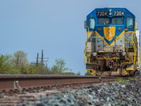 D&H 7304 leading a weed sprayer train, idles away in the Lovekin siding, awaiting a new crew that will bring it to Toronto. 

