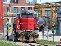 Goderich-Exeter Railway train X580 is viewed switching tankers at the Chemtura facility in Elmira, Ontario with GEXR GP38AC 3835 and LLPX GP38AC 2210.