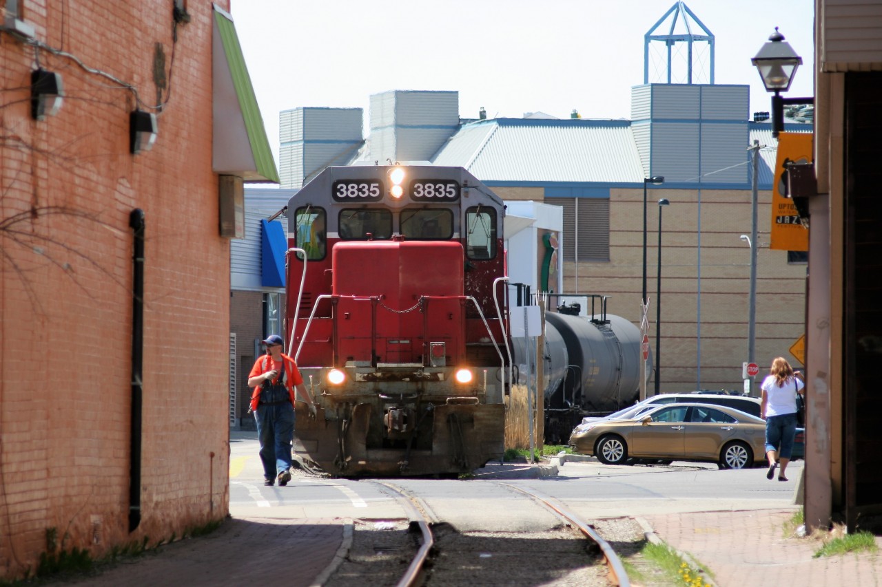 In a scene that has since been drastically altered due to the addition of the new LRT system, Goderich-Exeter Railway train X580 is seen approaching King Street in uptown Waterloo, Ontario with GEXR GP38AC 3835 and LLPX GP38AC 2210. The train is heading back to Kitchener from Elmira on the Waterloo Spur.
