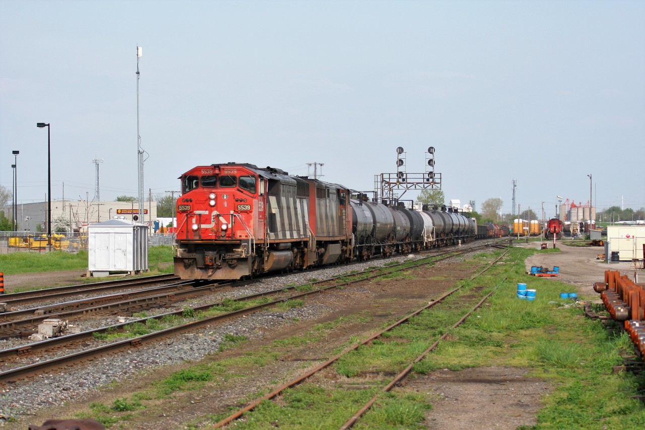 A westbound CN train with SD60F 5539 rolls through London Junction towards Sarnia with a sister draper unit.