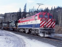 On a cool and overcast afternoon, "pusher power" is coupled on to a loaded coal train at Teck loadout waiting for a crew to push up the mountain. The 6001 will be the controlling unit for the pusher units, coupled to SD40's 762 & 761. The diesel units could be MU'd to the electric units in trailing and would be fully functional as trailing. If the scenario was reversed, the electric unit could not be operated from the diesel unit leading. the electric unit would have to be setup "dead in tow" with the pantograph down.