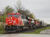 <b> Marcus W Stevens stated that "when it rains it pours - if the weather is bad then all the interesting power will show up".</b> On a recent and depressing trip last week to Sarnia, I ended up detouring to Wyoming. Of course, Mother Nature decided against my wishes for my time spent in that area for a nice sunny day. But note what follows lead engine 2977 across Broadway Street - 3 other units including slug #203 and an old friend in 7200. These units are usually seen shunting around the yards at Sarnia. And yes just off in the distance is VIA's little bus shelter they call a station, replacing a much larger building that once stood in the foreground.