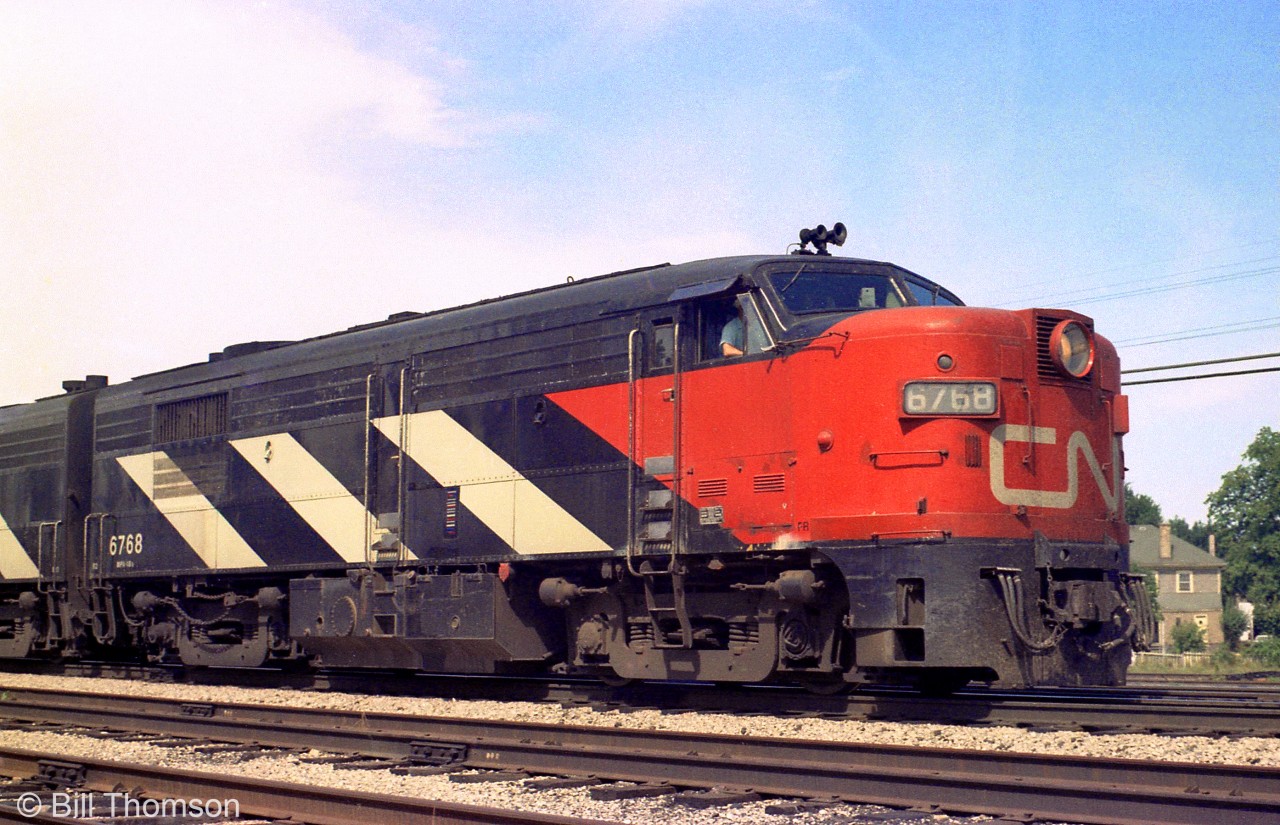 CN FPA4 6768, painted in the 1961 zebra stripe scheme, is shown leading eastbound at Strathroy in 1981. Built by MLW in January 1959 for CN, 6768 went on to serve VIA Rail, and eventually made its was to the Grand Canyon Railway as a parts unit for its active MLW sister units there.