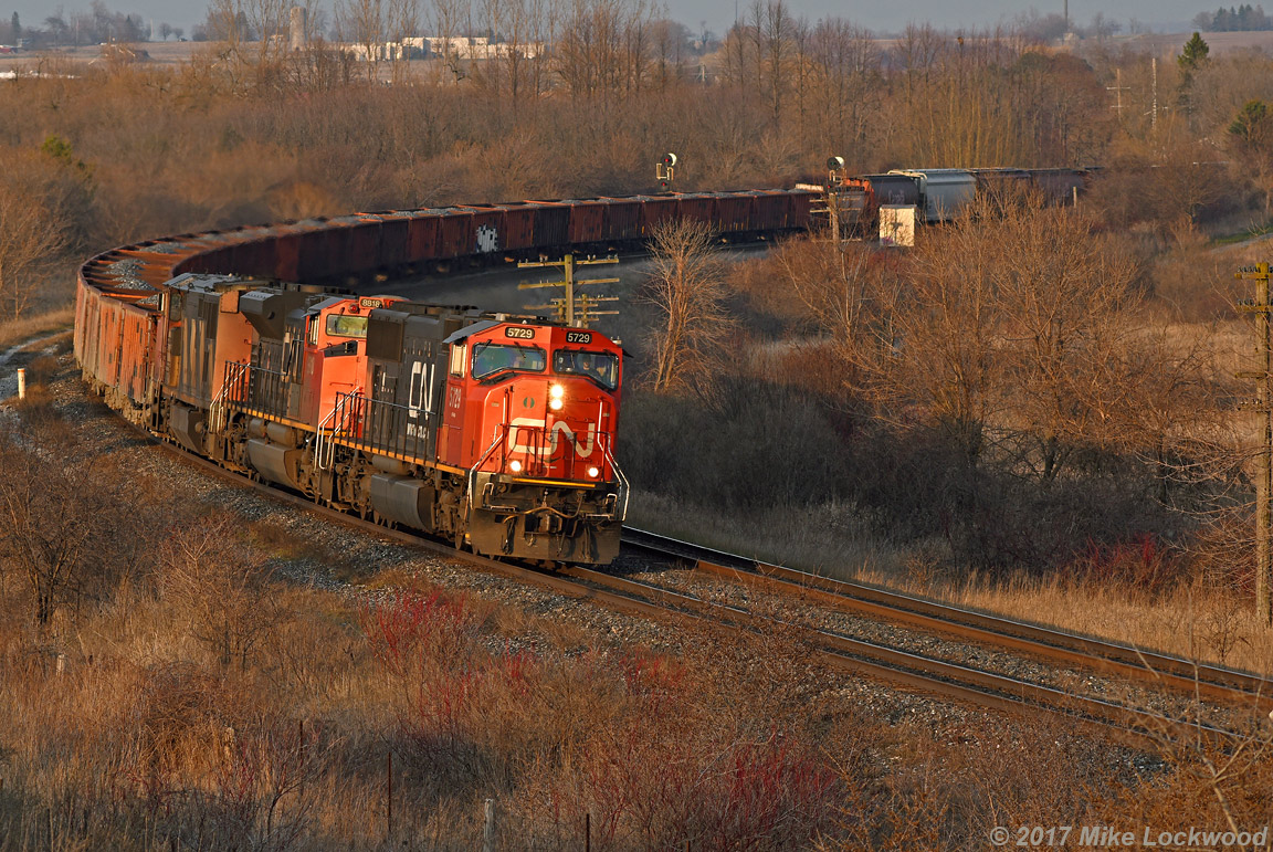 With a big slug of ballast loads on the headpin, one of the queens of the fleet leads 8818, 2413, and 369's train through the curve at Bowmanville. The trees are really encroaching on this location, guys... just sayin'. 1908hrs.