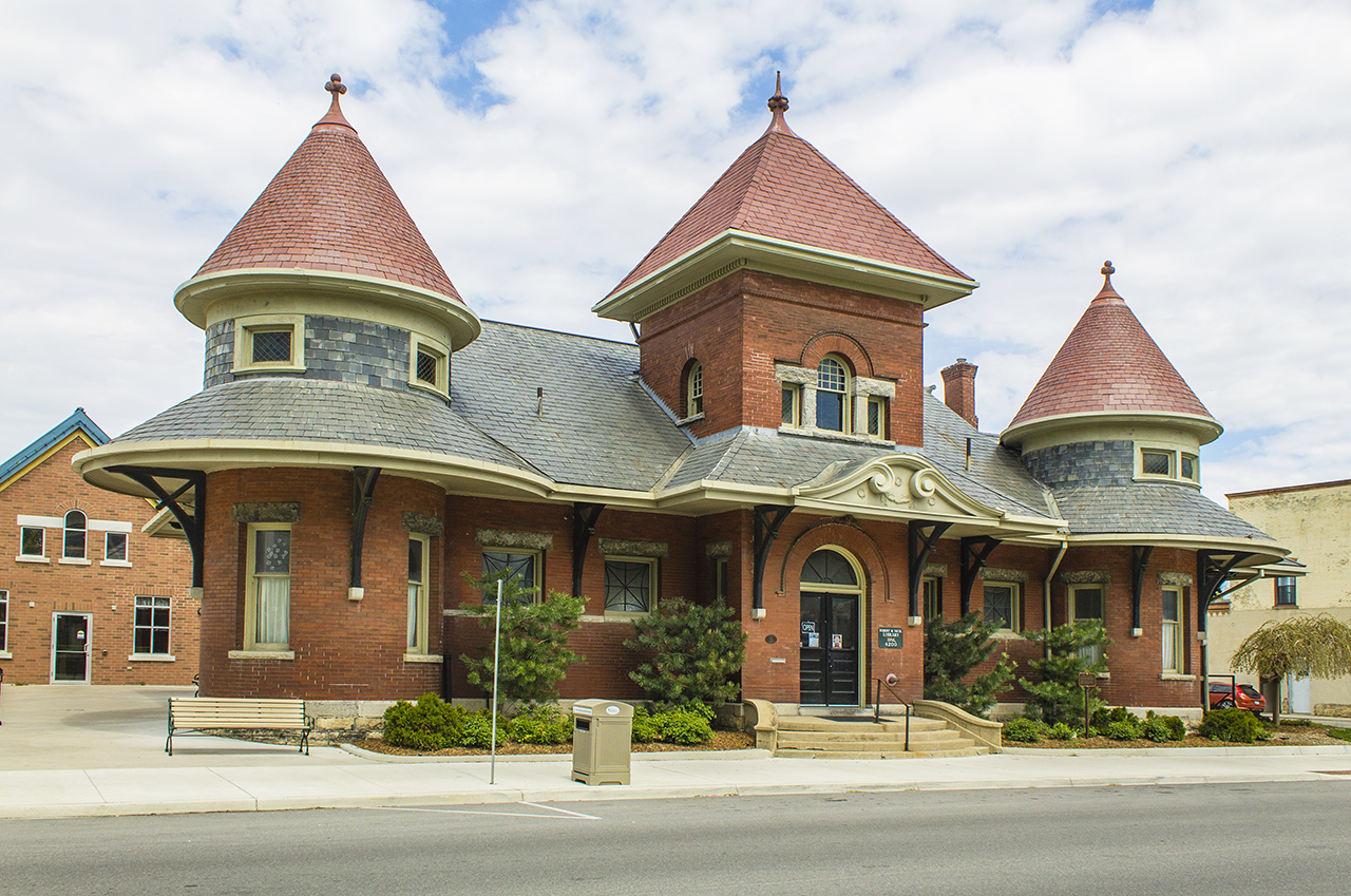 When the Great Western Railway built it's line, branching it off at London to Sarnia, they decided to tap into the oil boom that was happening in Lambton County. The main town, Petrolia, already had a railway when the Michigan Central also built a spur line to take advantage of the oil that was found so richly in this area.


Today, not much remains of the oil boom days. Smaller towns such as Oil City and Oil Springs, are only a shell of what they used to be. The Michigan Central pulled it's branchline through Lambton County in the early 60's. Most stations today have vanished from the landscape, but all is not lost. The last station standing in Petrolia, is in fact now used as their Public Library. CN ended passenger service on the line in 1930, and it's been a library ever since. Freight traffic continued on the spur line, until it too was finally lifted in the late 80's / early 90's. But the CN station is a gem. It has been well taken care of through the years.


Of note - the MC station for Petrolia was relocated and split into two to be used as a residence in Bright's Grove. The freight shed that was located in Petrolia - well, rumour has it it is used as part of the main building known as the "Oil Rig Restaurant"...just across the street from where it once stood. The former MC station for Oil Springs still exists, now part of the Oil Museum located there.