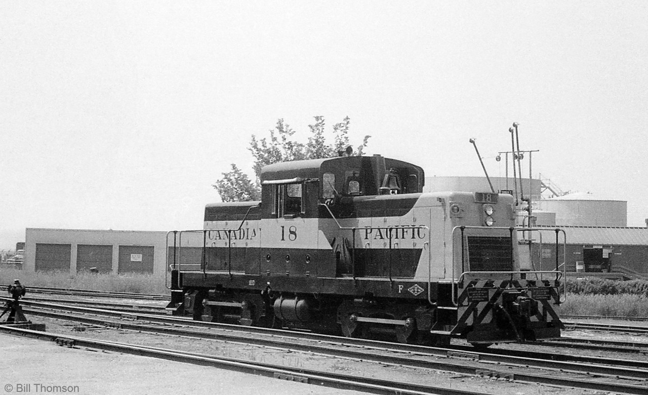 Only a few months old if that, Canadian Pacific HS5-class "DTC" switcher 18 is shown by the station at Goderich in 1959. CP ordered 14 of these little Cat-powered Diesel Torque Converter siderod switchers built by CLC of Kingston Ont. for local light switching duties across the system, and unit 18 was outshopped in May of 1959.

Sister DTC 17 was the regular unit assigned to Goderich since it was new in May of 1959, so 18 here may have been a substitute unit sent out while 17 was off getting maintenance or repairs done elsewhere.

CPR 6275, Goderich's regular steam switcher until the end of steam: http://www.railpictures.ca/?attachment_id=23837