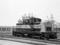Only a few months old if that, Canadian Pacific HS5-class "DTC" switcher 18 is shown by the station at Goderich in 1959. CP ordered 14 of these little Cat-powered Diesel Torque Converter siderod switchers built by CLC of Kingston Ont. for local light switching duties across the system, and unit 18 was outshopped in May of 1959.
<br><br>
Sister DTC 17 was the regular unit assigned to Goderich since it was new in May of 1959, so 18 here may have been a substitute unit sent out while 17 was off getting maintenance or repairs done elsewhere.
<br><br>
CPR 6275, Goderich's regular steam switcher until the end of steam: <a href=http://www.railpictures.ca/?attachment_id=23837><b>http://www.railpictures.ca/?attachment_id=23837</b></a>