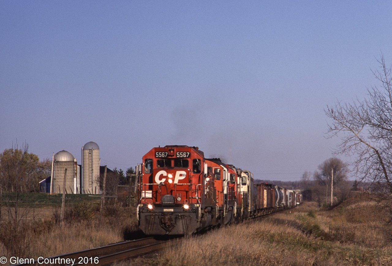 CPR SD40 5567 leads a mixed bag of power west of Newtonville.