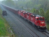 CP 2259, 2211, and 6259 lead an eastbound loaded ballast train at the east end of Spicer during a bit of a downpour. Fresh, clean ballast... what could be better? 1720hrs.