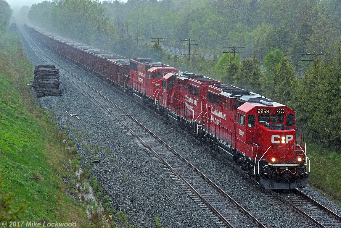CP 2259, 2211, and 6259 lead an eastbound loaded ballast train at the east end of Spicer during a bit of a downpour. Fresh, clean ballast... what could be better? 1720hrs.