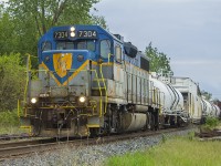 <b> Good things come to those who wait! </b> This photo represents a coming of full circle...D&H 7304 was first spotted in Ontario about two weeks ago. Since them it has been a part of CP train 2WGA-19 - the Spray Train. As luck would have it, there was something different about the lead engine's headlights that caught my eye. This, after an hour of waiting - was worth it to see the yellow, blue and gray of D&H 7304 moving at a steady clip of approx. 30 MPH with it's otherwise not so exciting train of spraying equipment. 