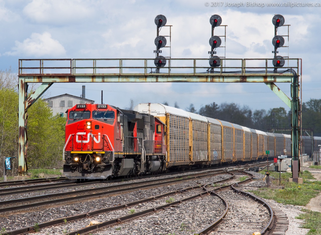 On a gorgeous afternoon, CN 271 ducks under the signals at Paris with CN 2153 and CN 5446 providing the power on this empty unit autorack train.