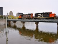 There is high water all over North America this spring, and where the Lachine Canal empties into the St. Lawrence River in Old Montreal is no exception. Here CN 4773 & CN are stopped on a bridge over the water, waiting for security to flag the crossings before they can proceed.