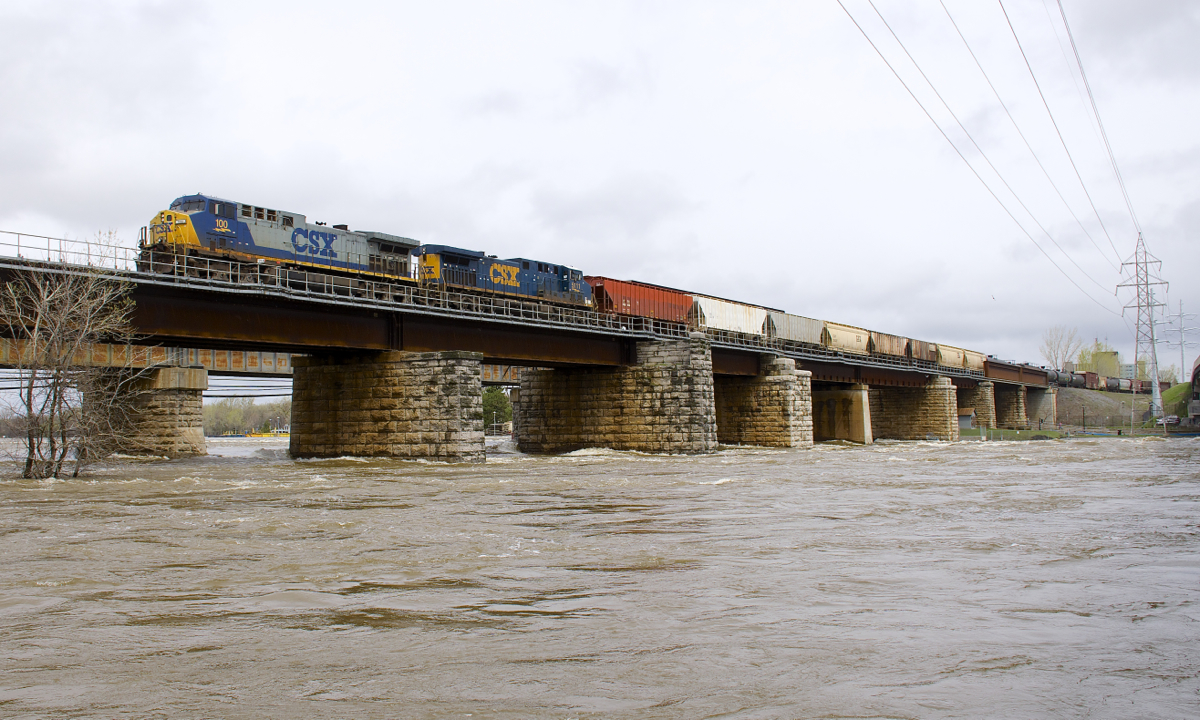 With more rain over the weekend, the water levels keep rising in the Montreal area. The army has been called in and there is flooding on both the island of Montreal itself, as well as other surrounding islands. I fact, the highway that I drove to to get here (highway 20) was just closed here. CN 327 has CSXT 100 (in clean YN2 paint) and CSXT 5111 (both AC4400CW's) as it crosses the flood-swollen river a bit after noon today.