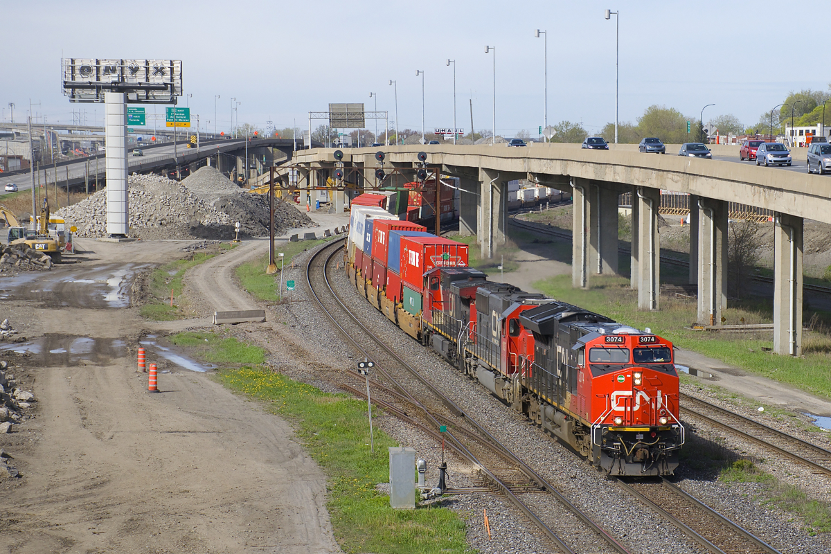 CN 120 has CN 3074, IC 1037, CN 2600 and DPU CN 2685 for power as it passes MP 6 of CN's Montreal Sub. At left is where the Lachine Spur used to leave the main line. This Toronto-Halifax intermodal train is 592 axles long on this sunny morning.