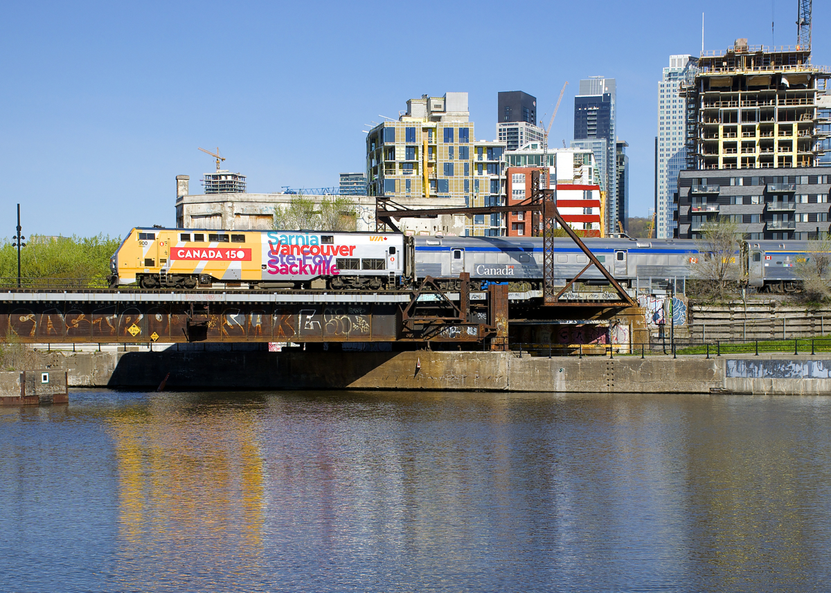 VIA 63 is passing Wellington Tower 5 minutes after leaving Central Station in Montreal. Power is class leader for VIA Rail's P42DC's (VIA 900), which is wrapped for Canada's 150th anniversary.