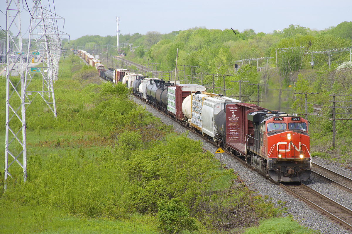 A bit of everything the length of the train. CN 310 (which runs from MacMillan Yard in Toronto to Joffre Yard near Quebec City) often has a bit of everything, and it's no exception as it passes through Beaconsfield, with tank cars, hoppers, empty and loaded centrebeams, autoracks (and more) sprinkled through the length of the train. Power is CN 2276 and CN 8010 mid-train and the train totals 640 axles.