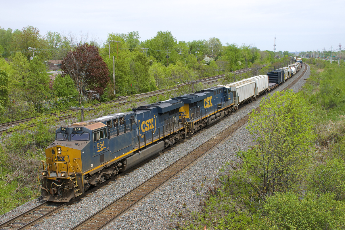 A pair of CSXT ES44AH's with steerable trucks (CSXT 954 & CSXT 813) lead CN 327 around a curve in Beaconsfield.