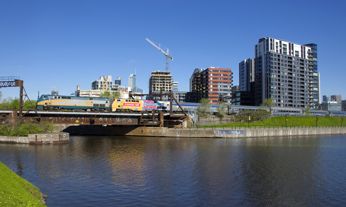 With 17 of VIA Rail's 21 P42DC's wrapped for Canada's 150th anniversary, it's getting rarer to get a non-wrapped one leading; it's also rare to see two P42DC's at the head end of any VIA Rail train. But here unwrapped VIA 902 and wrapped VIA 906 lead VIA 63 by the Peel Basin on a gorgeous morning.