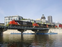 CN 149 is leaving the Port of Montreal with two standard cab units that CN picked up secondhand (SD60 CN 5482 & C40-8 CN 2100), with CN 2648 third. The train is leaving the port a bit later than usual as it crosses the Lachine Canal.